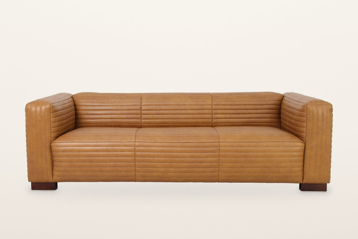 Pontremoli sofa from the front: three seat cushions, three back panels and two square block arms, all channel-stitched, on four block feet