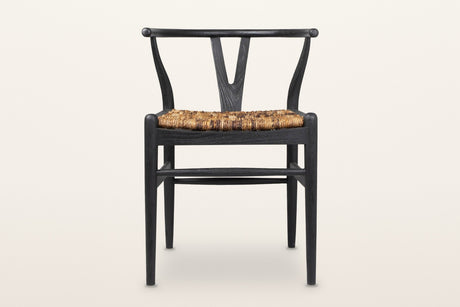 Poppi Y-back dining chair in Black, front view on a warm white studio backdrop: a black teak frame with a natural abaca seat