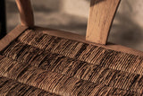 Close-up of the Poppi seat in Brown: plump rolls of woven abaca set side to side in a frame of flat reclaimed teak boards