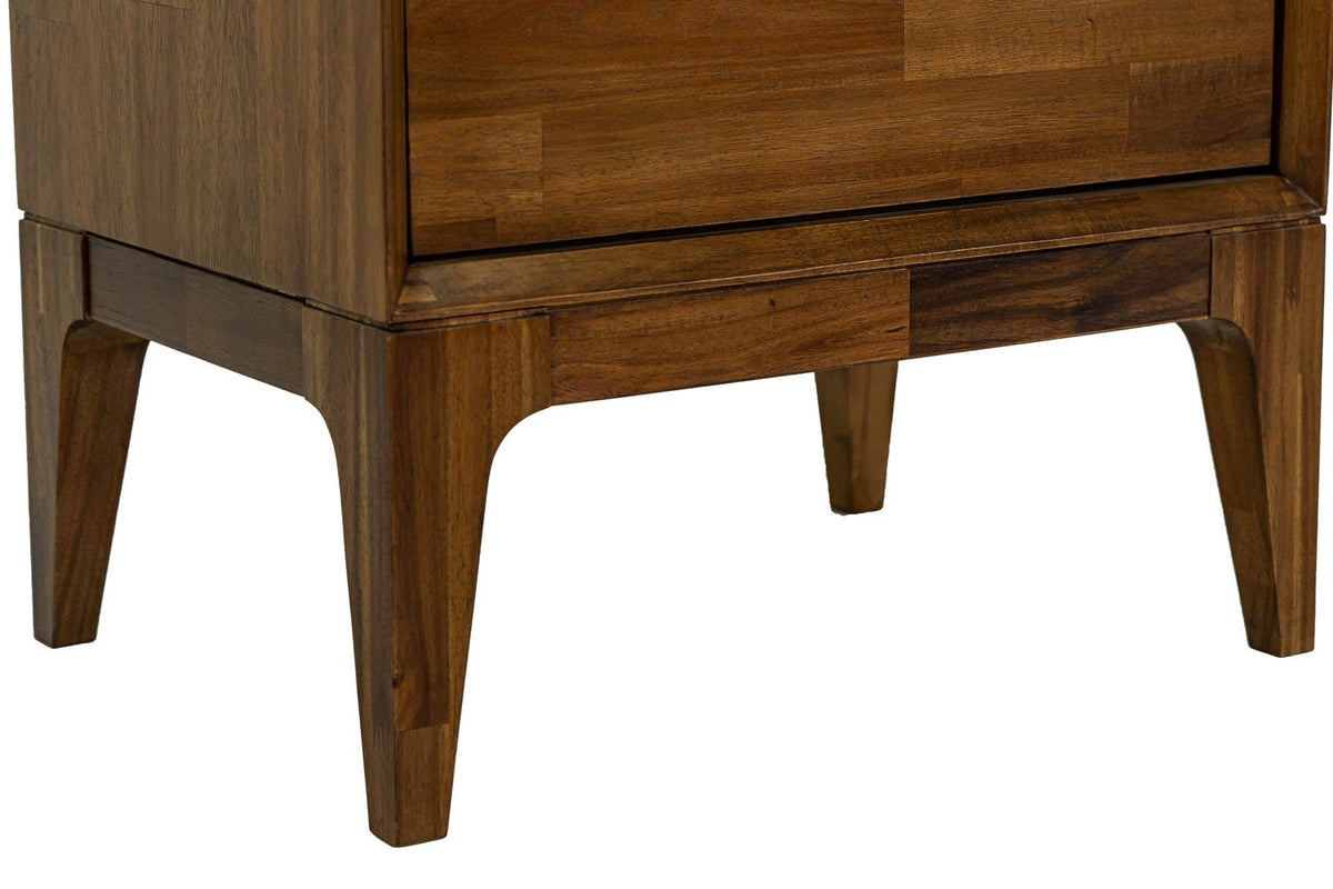 Close-up of the Postignano base: the apron with curved inside corners and the tapered acacia legs