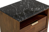 Close-up of the Postignano nightstand: the black marble top with white veins over the open niche and the brass tab pull on th