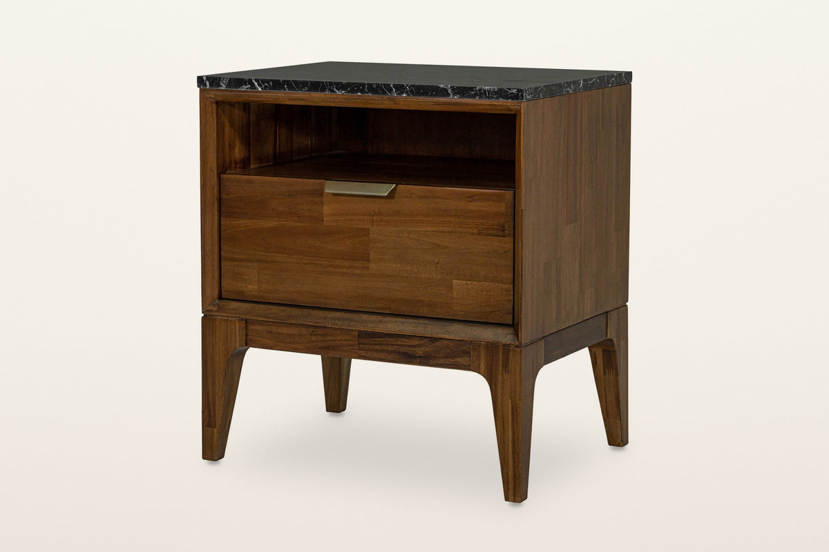 Postignano nightstand in Walnut, lower three-quarter view on a warm white studio backdrop: the black marble top