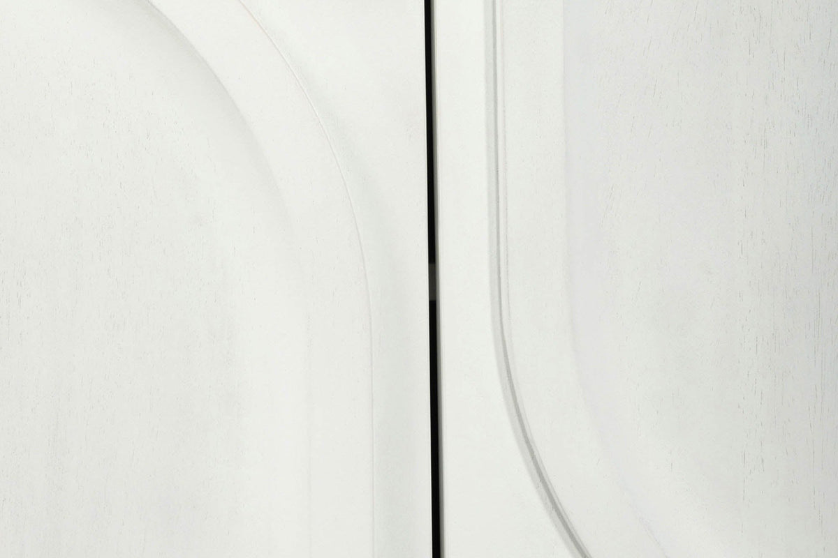 Close-up of two Pragelato doors: the curve of a raised arch beside the straight side of a raised inverted arch, white wash over a fine mango grain