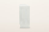 The right end of the Pragelato sideboard: a plain flat end panel over the plinth, set back under the case