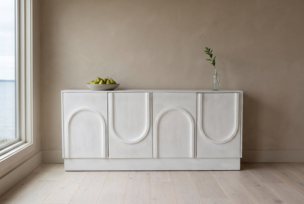 Pragelato white sideboard against a clay-beige plaster wall in a Saint Andrews, New Brunswick dining room, a bowl of pears on top