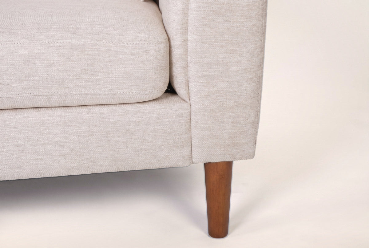 Close-up of the arm front and a tapered wood leg in a brown finish