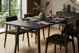 Prescott antique black dining table set for dinner in a bright dining room