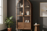 Prescott brown arched display cabinet styled with ceramics and books against a charcoal wall
