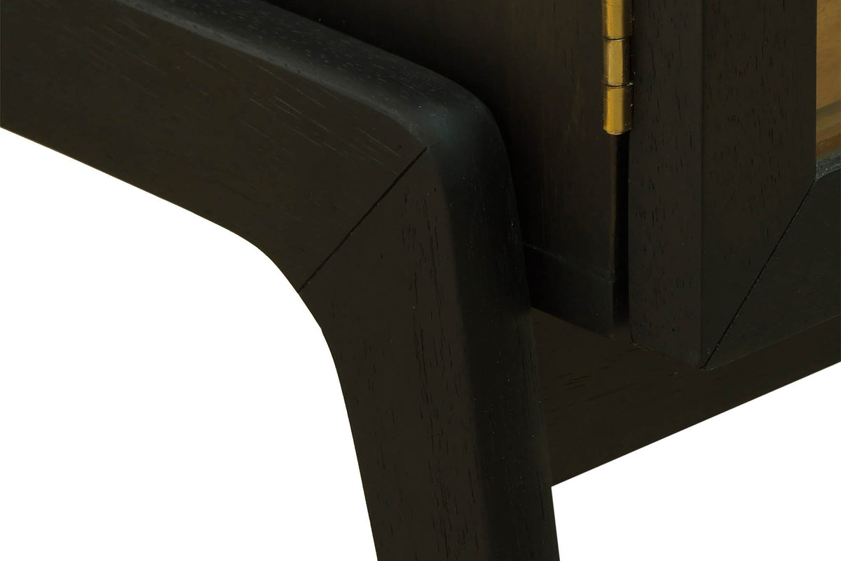 Prescott black cabinet close-up of the curved leg and brass hinge