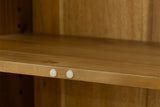 Prescott black cabinet close-up of a natural acacia shelf resting on pins
