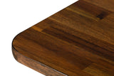 Close-up of the Prescott table in Brown: the rounded corner, the thick edge and the staggered short acacia boards of the top