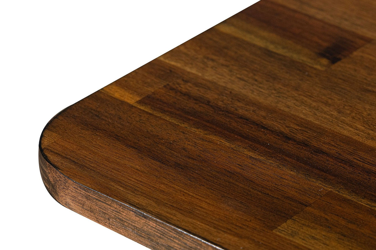 Close-up of the Prescott table in Brown: the rounded corner, the thick edge and the staggered short acacia boards of the top