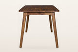 End view of the Prescott extension dining table in Brown: two round tapered legs splaying out from the apron, each with a small curved notch