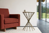 Side view of the Rango side table beside a rust boucle armchair in a Gstaad summer chalet, with white plaster