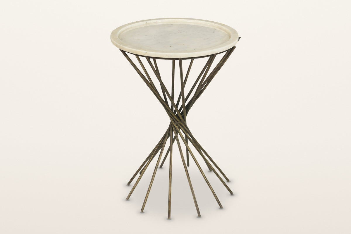 Rango round side table seen from above at three-quarter on a warm white studio backdrop: a white marble-look tray top on cros