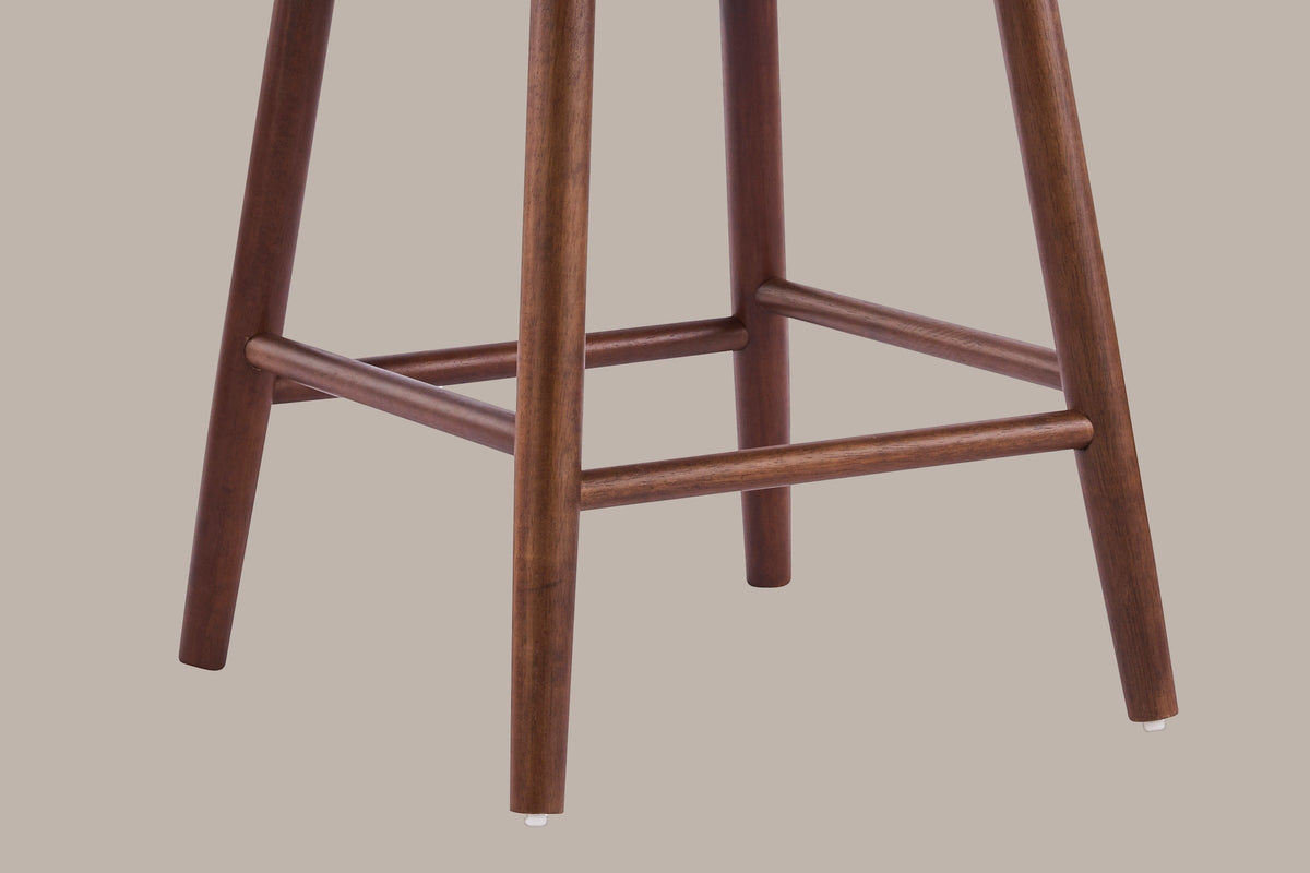 Close-up of the Rasiglia tapered walnut legs, the box of four round rails and the white glides