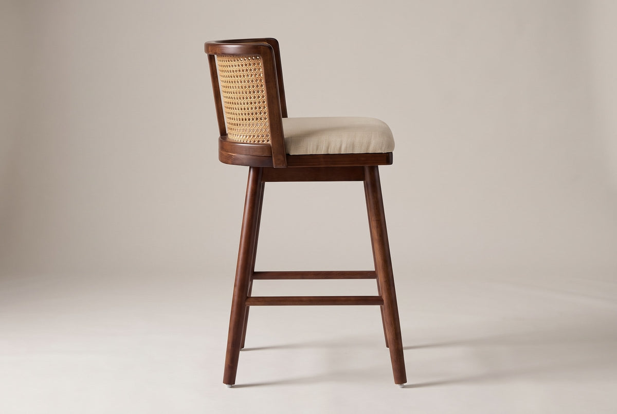 Rasiglia counter stool in side profile: curved back, raised seat frame, four splayed legs and the rails at 8.25 inches