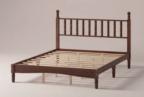 Ravenna wood spindle bed in Walnut, three-quarter view on a warm off-white studio backdrop