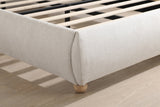 Close-up of a domed foot corner in beige chenille on a solid oak ball foot, with the slats inside