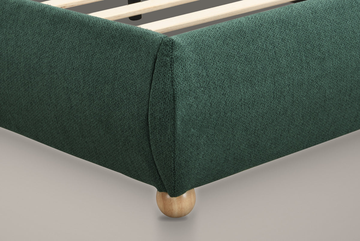 Close-up of a domed foot corner in forest green chenille on a solid oak ball foot, with the slats inside