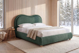 Recanati cloud bed in forest green chenille in a cedar-clad cabin bedroom with snowy spruce forest through a tall window