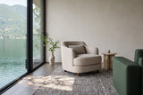 Ripatransone accent chair in Beige in a Belcarra house on Indian Arm, beside a green wool sofa and a travertine side table