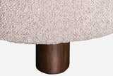 Close-up of a Ripatransone leg: a short round dark brown rubberwood leg under the textured fabric base