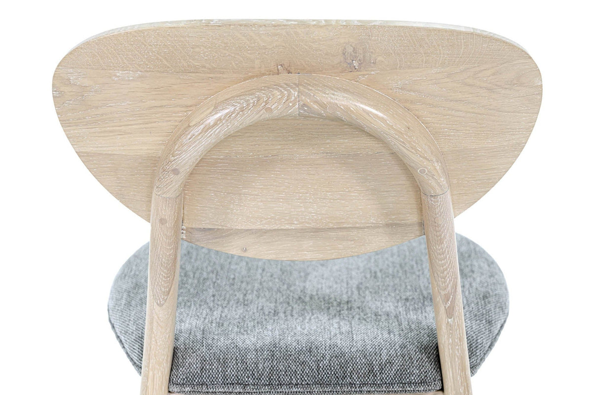 Close-up of the Rivello back from behind: the bent oak arch, its joint at the top and the oak grain of the back panel