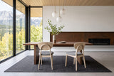 Two Rivello dining chairs seen from behind at a walnut table in a Radium Hot Springs house