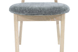Close-up of the Rivello seat: the Toffee Mist pad with its self-piped edge on a plain oak apron and square front legs