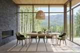 Rivello dining table in Light Oak in a Smithers house, with a dark slate wall and fireplace, a woven pendant