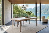 Rivello dining table in Light Oak in a Ticino stone house above Lake Lugano, with a board-formed concrete wall