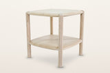Rivello side table in Light Oak at eye level, three-quarter view on a warm white studio backdrop: four round legs outside
