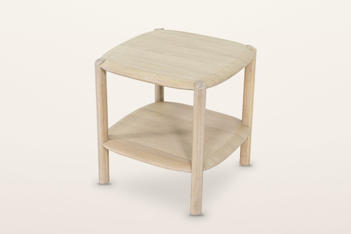 Rivello oak side table in Light Oak, three-quarter view from above on a warm white studio backdrop: a soft square top