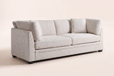 Rovigo flared-arm sofa in beige chenille, three-quarter view on a warm off-white studio backdrop