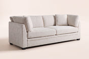 Rovigo flared-arm sofa in beige chenille, three-quarter view on a warm off-white studio backdrop