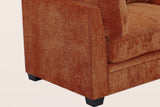 Close-up of the caramel chenille arm, the base seam and two black tapered legs