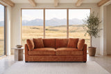 Rovigo sofa in caramel chenille in a Calgary foothills great room with a window onto grassland and the Rocky Mountains