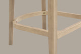 Close-up of the D-shaped wooden footrest of the Natural Ash Sabaudia counter stool with its exposed brass-tone hex bolts