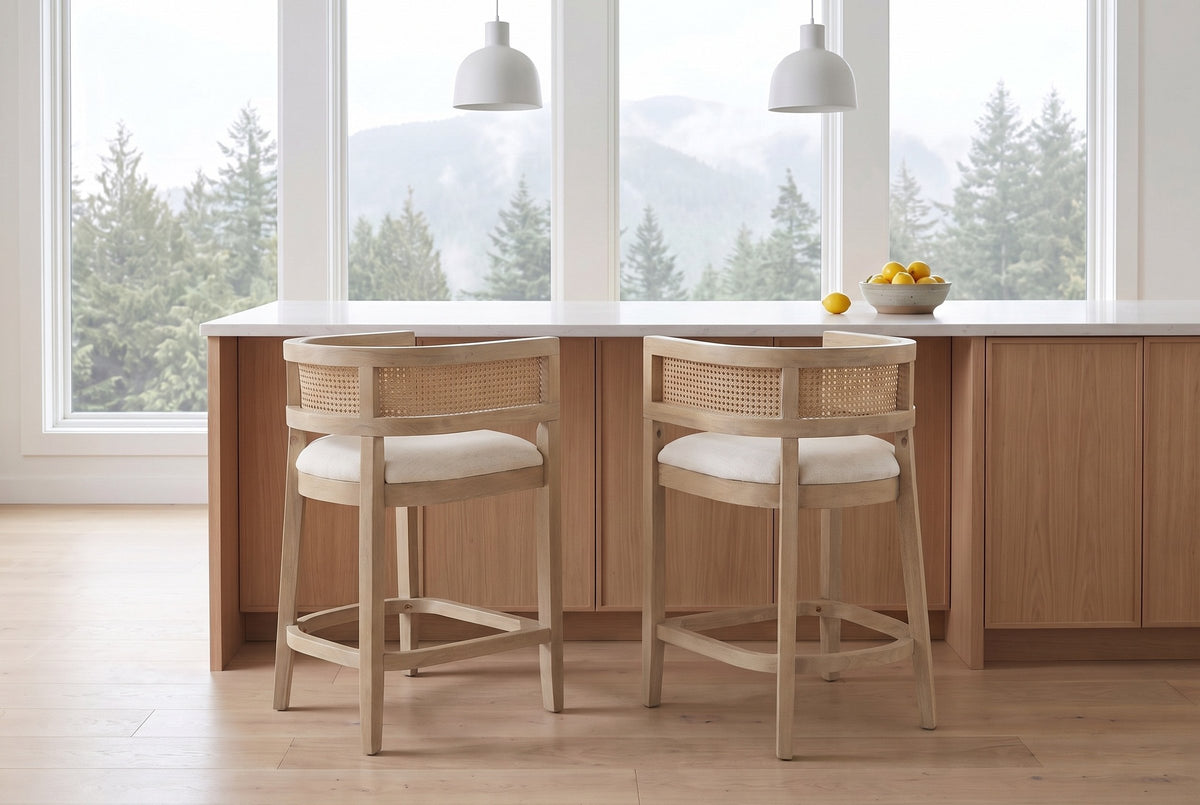 Two Sabaudia counter stools in Natural Ash pulled out from a white-oak kitchen island in a Vancouver townhouse in morning lig