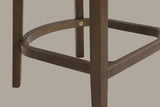 Close-up of the D-shaped wooden footrest of the Walnut Sabaudia counter stool with its exposed brass-tone hex bolts