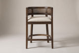 Sabaudia counter stool in Walnut, straight front view showing the barrel back, the cane-look band, the footrest and four legs