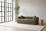 Sabbioneta sofa against a white brick wall in a bright Montreal loft, an olive tree by the steel windows