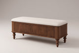 Salerno reeded storage bench in walnut with an ivory linen-look seat, three-quarter view on a warm grey studio backdrop