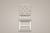 One Saluzzo dining chair, straight front view: arched button-tufted back, padded seat, white legs with a low stretcher