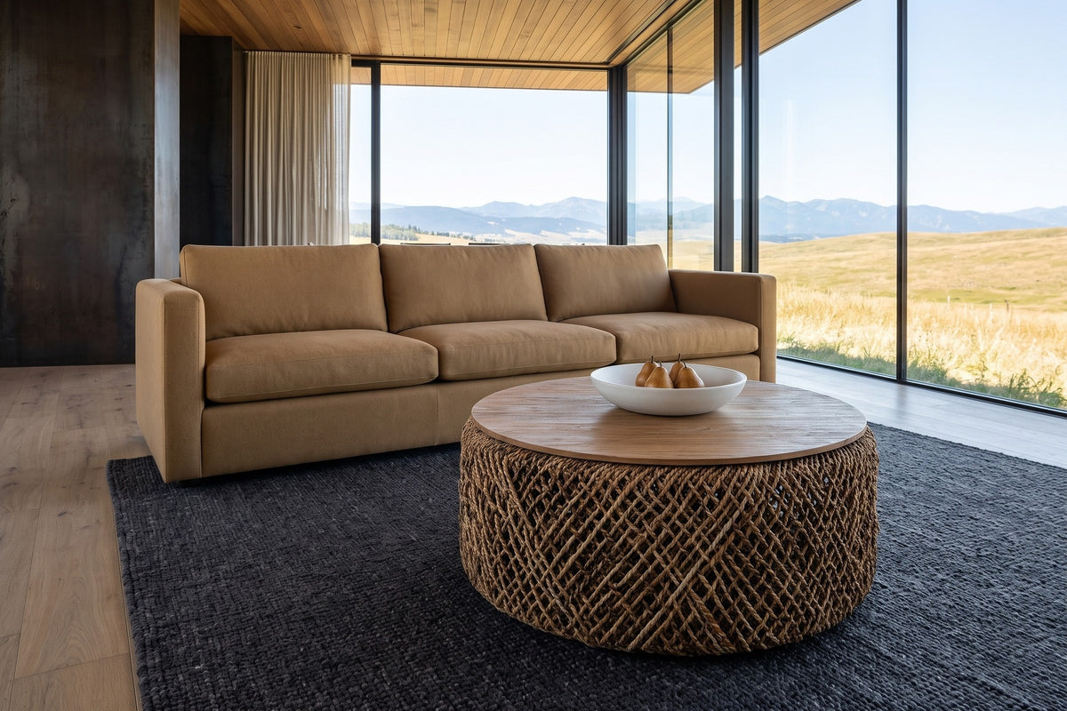 Sambuca coffee table seen from above in an Okotoks foothills house, with a corten wall, a charcoal wool rug