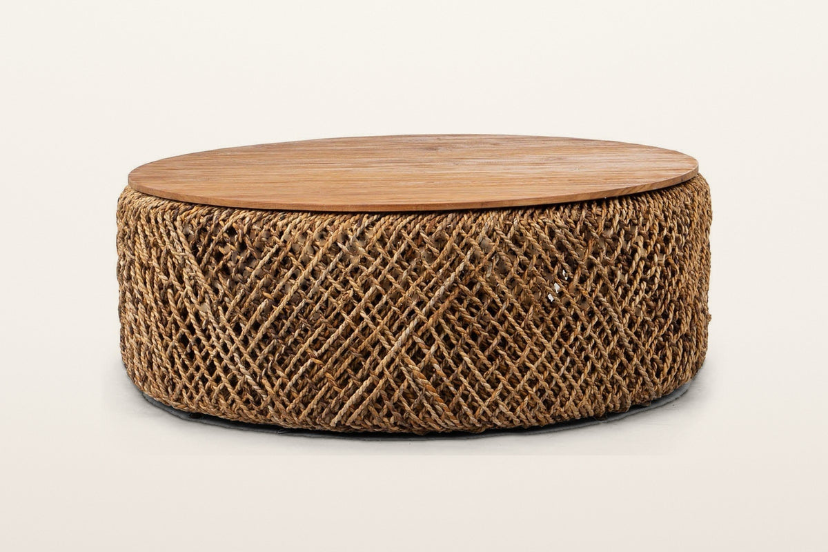 Sambuca round coffee table in Natural, front view on a warm white studio backdrop: a thin reclaimed teak top on a low drum