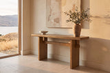 Sanremo console table in antique brown in a limewashed lake-house entry in late sun, olive branches in a clay vase