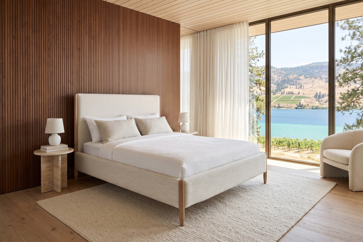 Sarnano bed in Alabaster fabric with Sand oak posts in a bedroom in a Coldstream house above Kalamalka Lake
