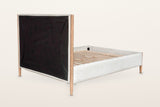 Sarnano bed from behind the headboard on a warm white studio backdrop